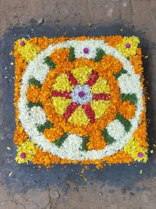 Onam pookalam in traditional poothara. Geometric design on the ground made out of flower petals.