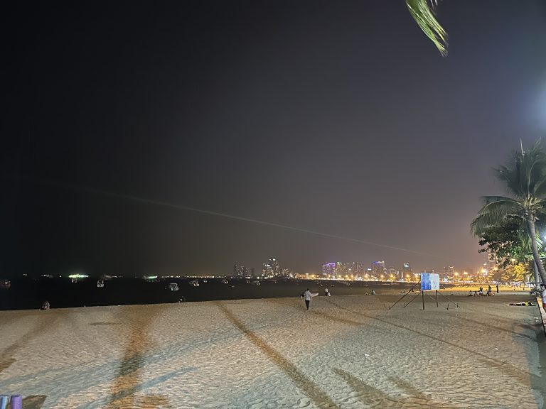 Night view of Pattaya City with beach in the foreground