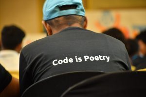 Photo taken from WordPress Youth camp - Wearing T-shirt with WordPress tagline "Code is Poetry"