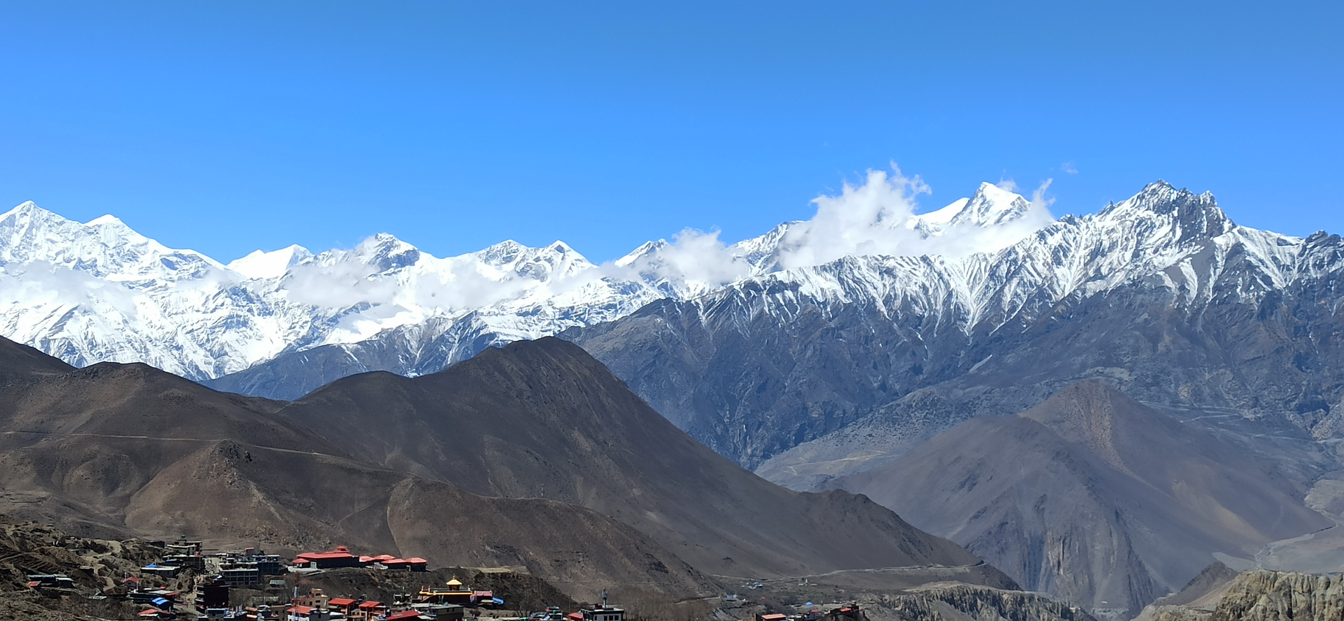 A view of Snow-capped mountains and hills of Nepal from a village. 