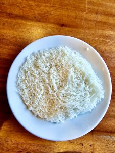 Idiyappam or Noolputtu made of rice flour, salt and water prepared by steaming . A popular break fast in kerala, India.