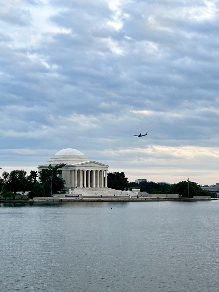 A plane flighting over the Jefferson Memorial in Washington DC