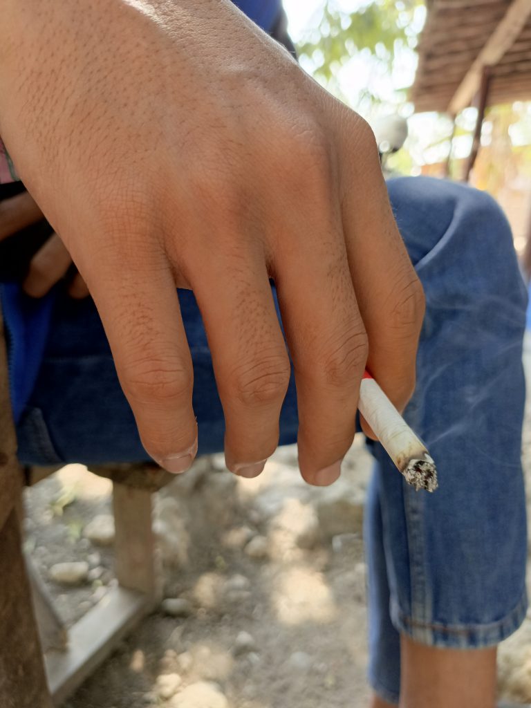 Hand holding a cigarette