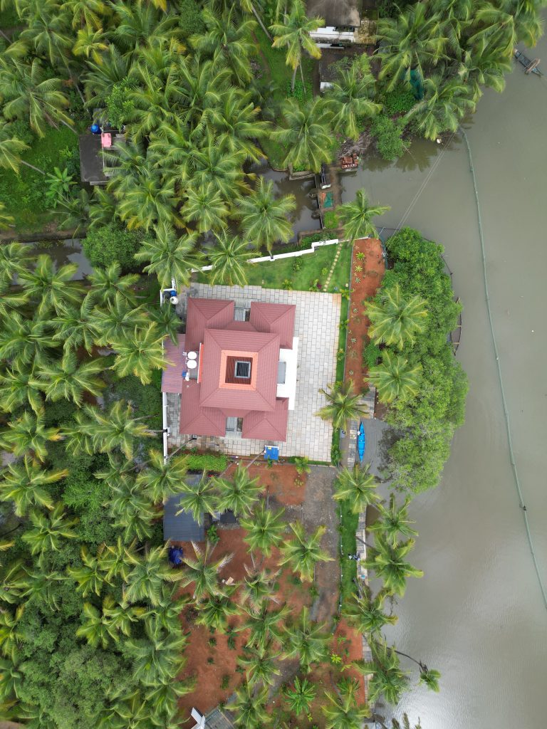 Aerialview of resort with palm trees, canoes, a building and a river #WPPhotoFestival