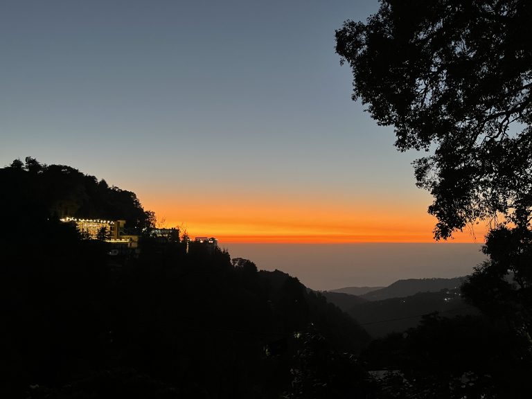 A sunset on the mountain. Breathtaking view of mountain with lights and trees and perfect sky!