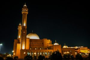 Architectural elegance meets spiritual serenity in this captivating photo of a mosque, its intricate details and graceful minarets against a clear sky.