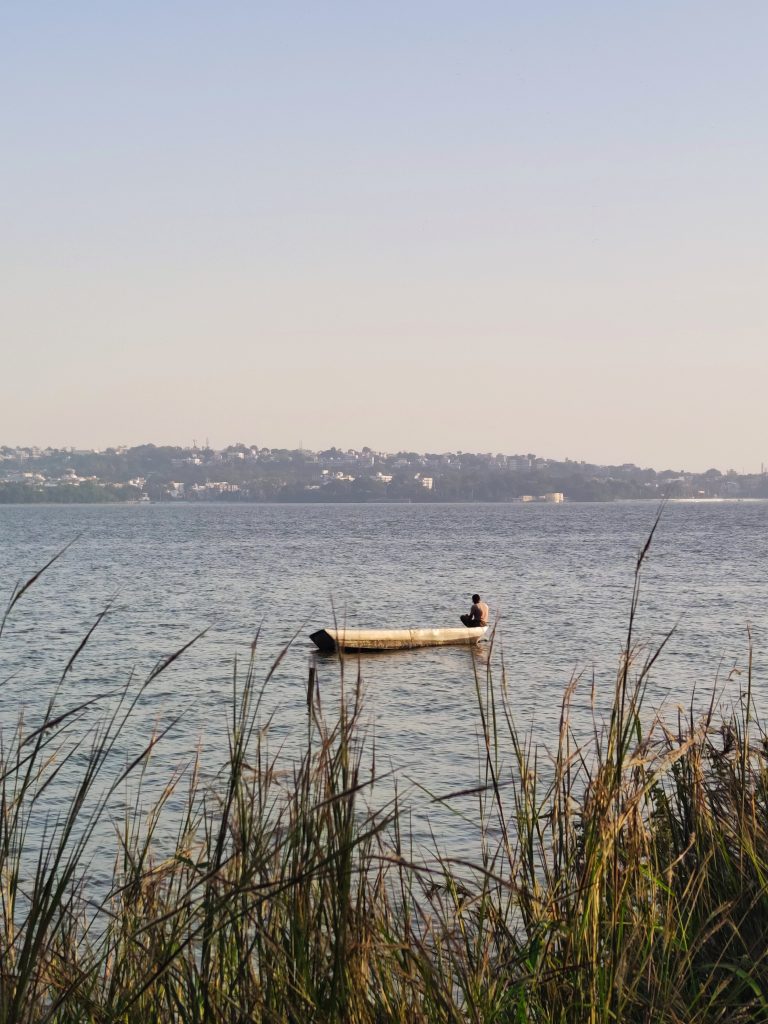 A fisherman waiting patiently for fish to be caught.