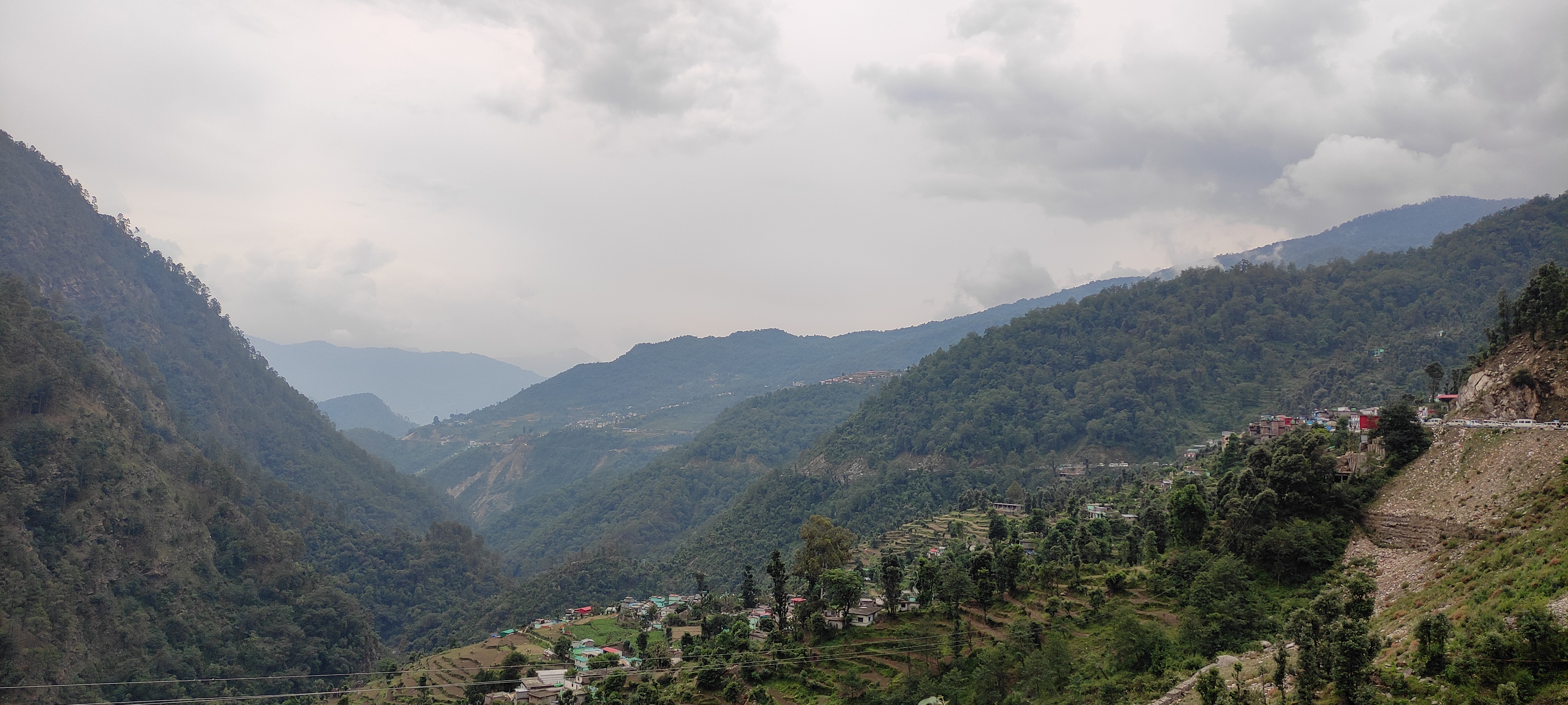 Looking down a valley between mountains and villages.