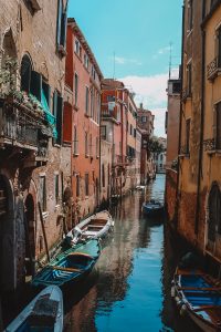 Looking down on boats in a colorful, Venice canal. 