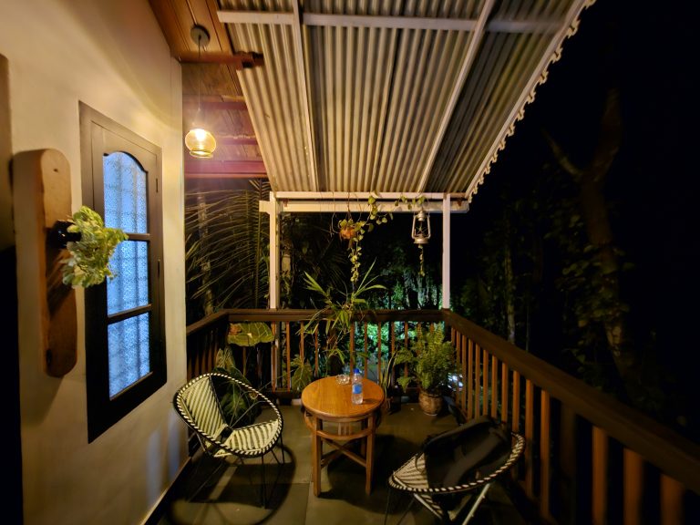 Cozy balcony of a tiny house during night.