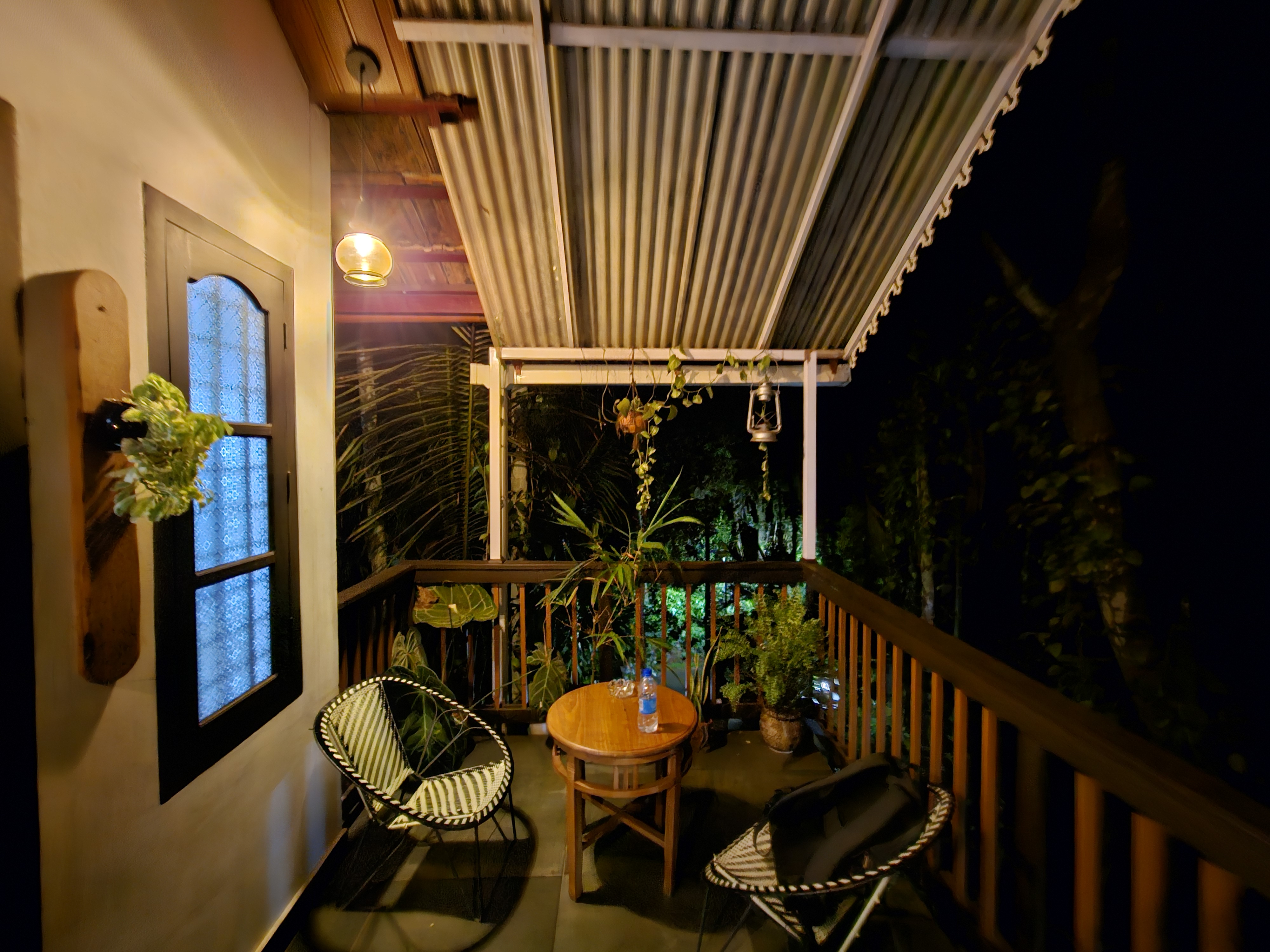 Cozy balcony of a tiny house during night. 