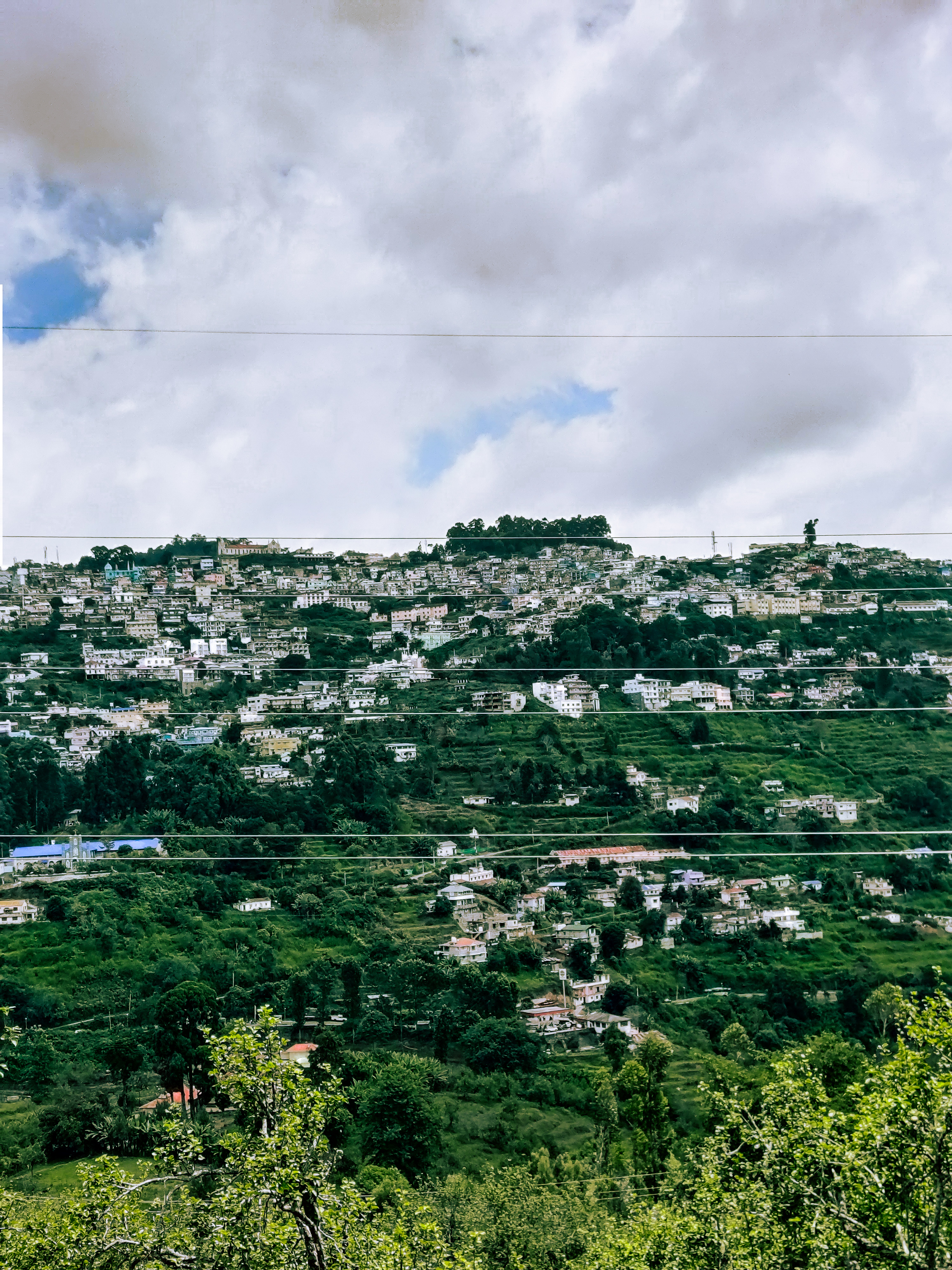 A view of Kodaikanal town where most of the buildings are white in color. 