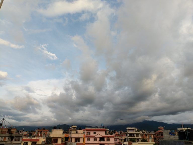 Houses with floating clouds in background