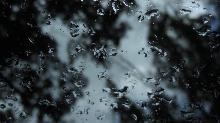 Remains of heavy rain on windshield. Calmness after a storm.