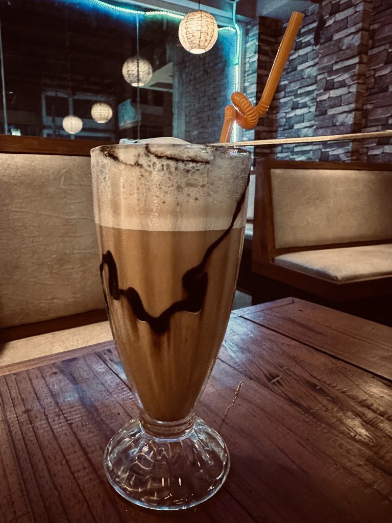 Chocolate Frappe with chocolate and ice cubes in it.