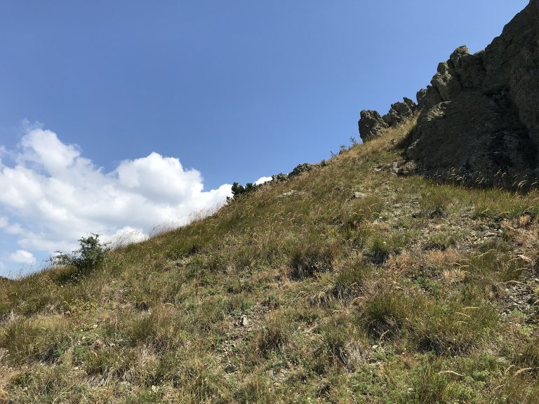 A mountain top ridge splitting the blue sky diagonally