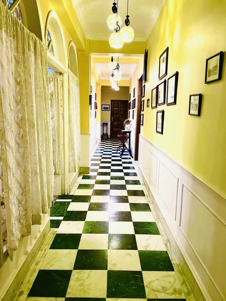 A black and white corridor with yellow lighting