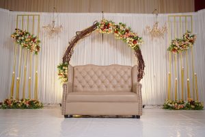 Stage decorated for wedding including flowers, lights and a sofa. Photo taken in kondotty - Malappuram