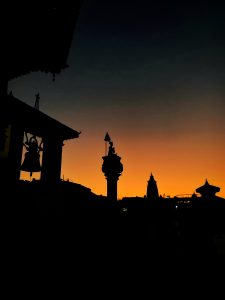 King Bhupatindra Malla statue located in Bhaktapur Durbar Square in silhouette against the sunset