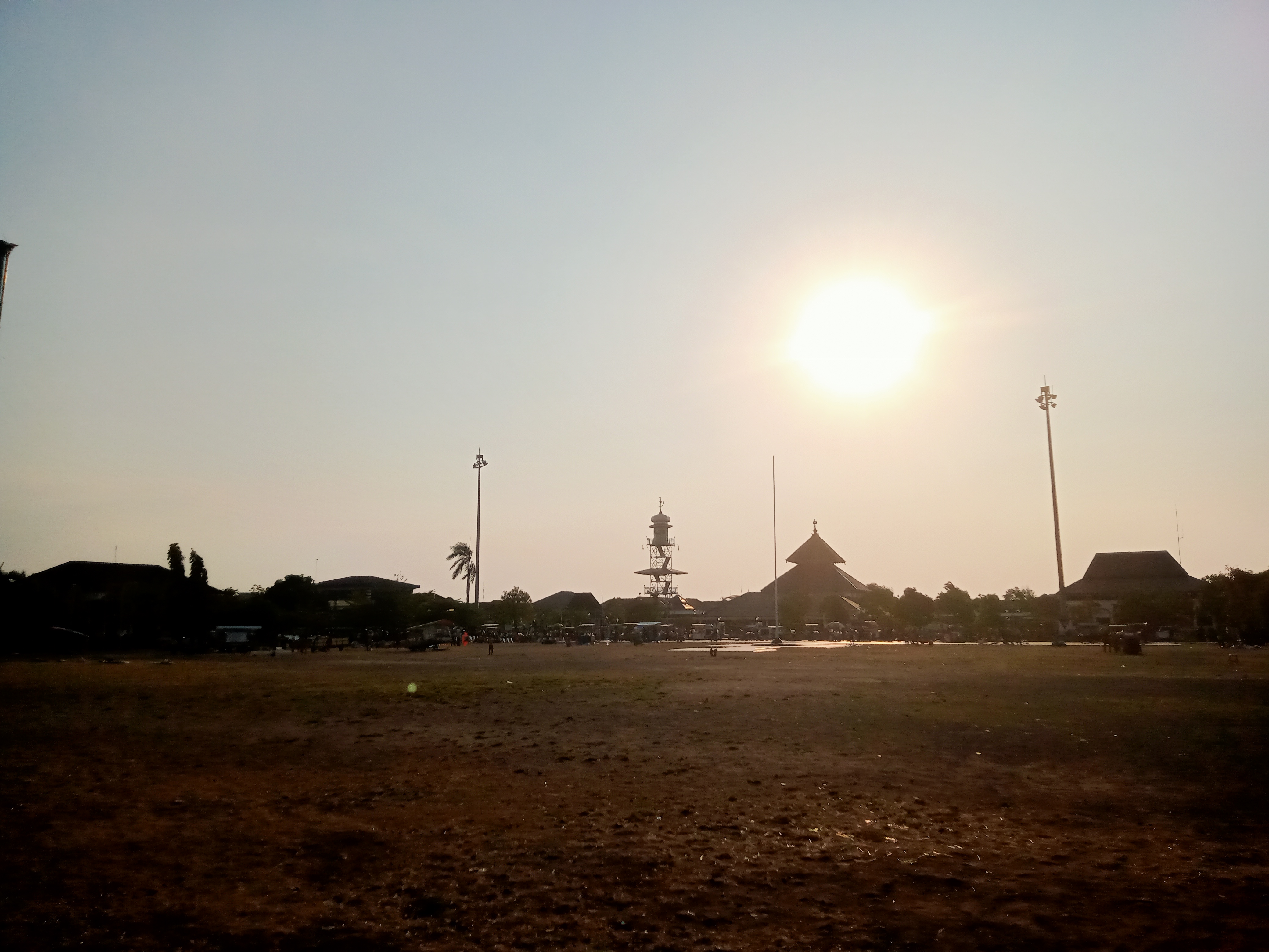 The Masjid Agung Mosque, also known as the Demak Great Mosque, in Indonesia, photographed in the afternoon, with the sun shining bright behind it. 