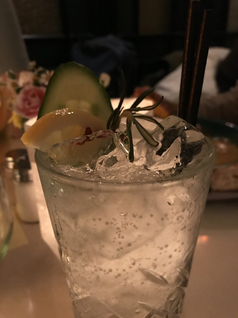 A cocktail in a tall glass with ice