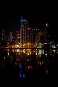 A snapshot of urban allure: Bahrain's city lights twinkle against the night, blending tradition and progress in a captivating dance of architecture and innovation