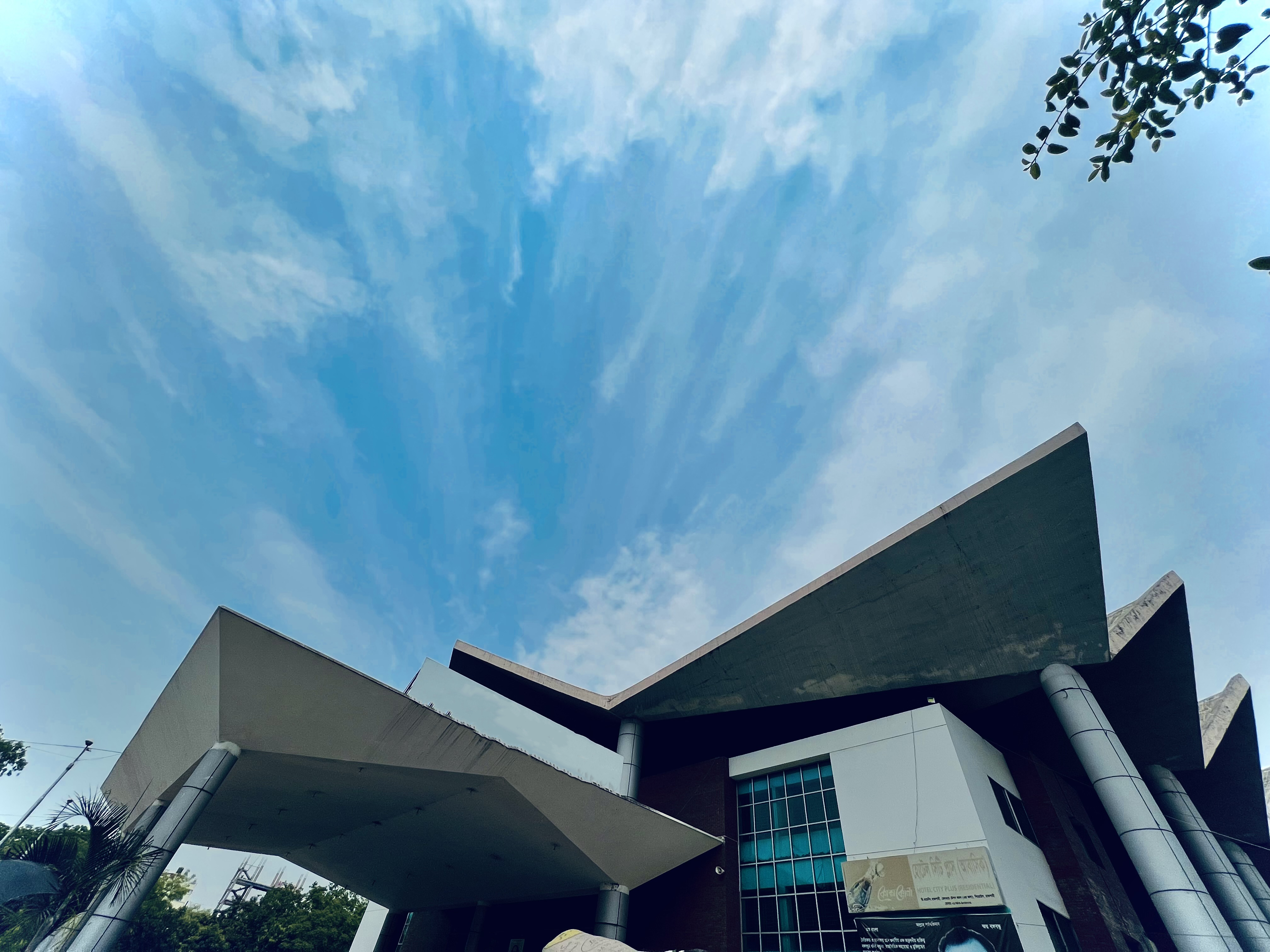 A building with multiple angled roof against a blue sky