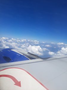 A view from the plane window. The clouds look like soft white cotton candy, slowly growing and changing with every passing second.
