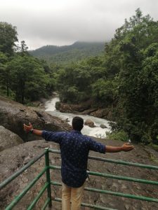 Man looking into waterfall 