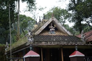 The roof of a temple with a statue at the roof peak