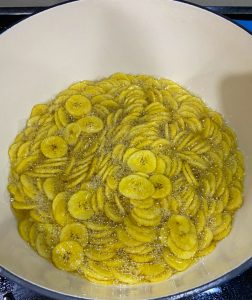 Making of banana chips! Banana chips boiling in the hot oil in a pan. 