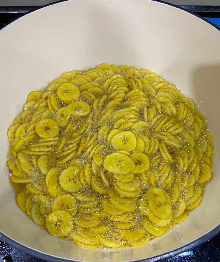 Making of banana chips! Banana chips boiling in the hot oil in a pan.