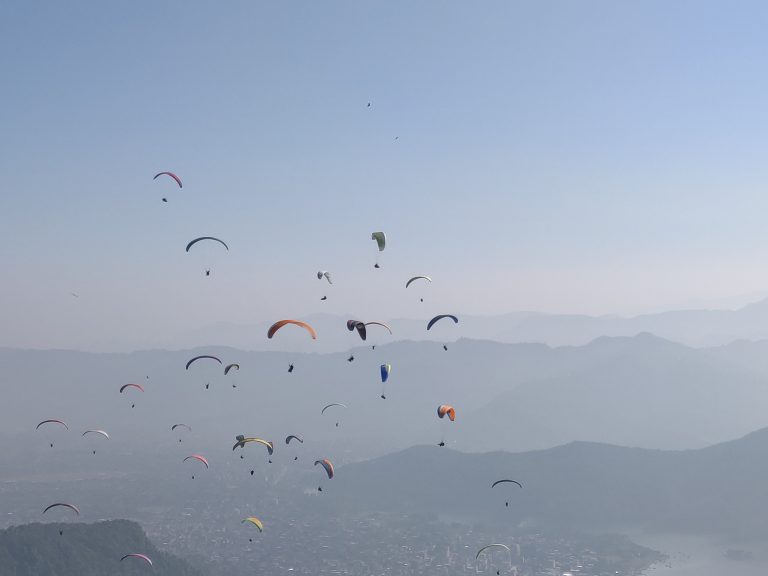 Many people paragliding in the sky of Pokhara.