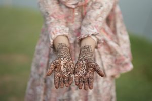 Mehandi design, elaborate henna artwork on two hands, going up the arms