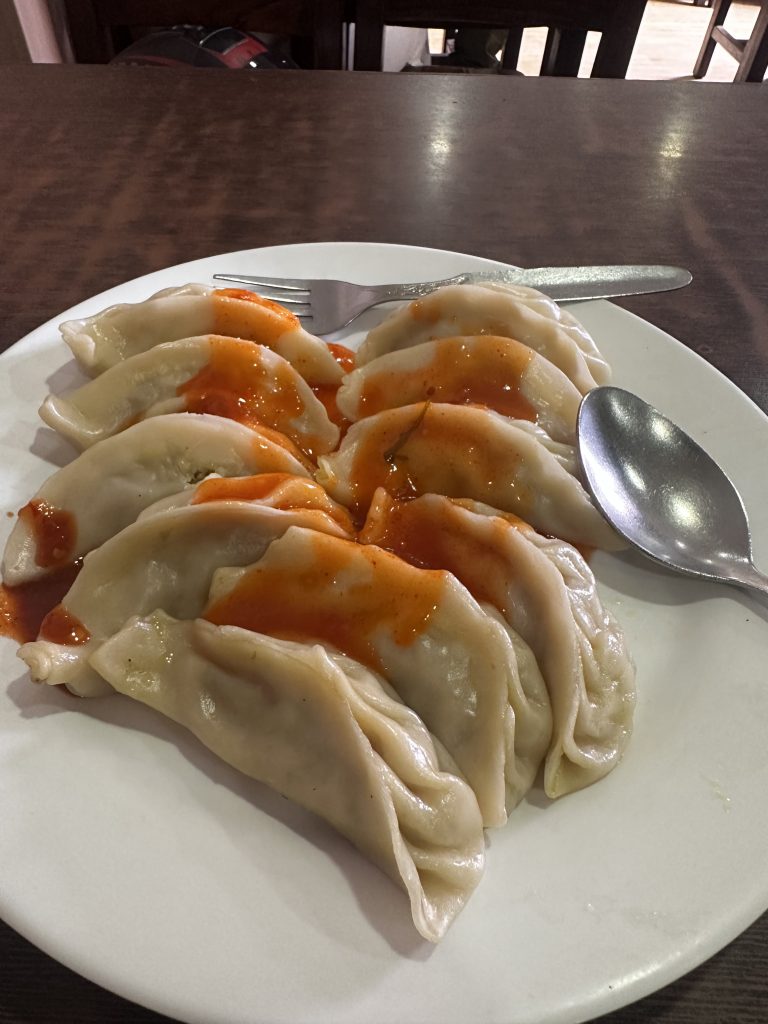 Momo. Dumplings with a light sauce on top.