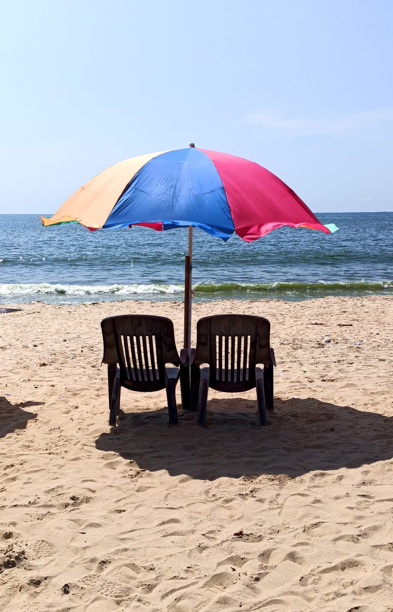 Chairs and an umbrella on the beach.