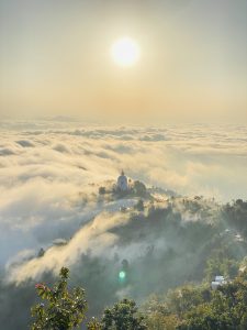 A Temple in the top of clouds in background.