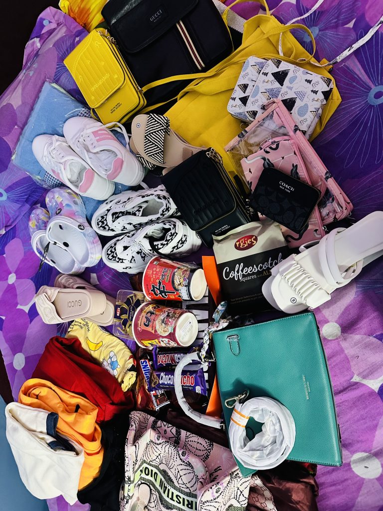 Collection of gifts including bag, shoes, towels, etc.