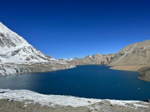 Breathtaking scenery of Tilicho Lake surrounded by majestic mountains.