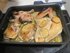 Turkey in a pan, right after coming out of the oven.  Covered in lemon slices.