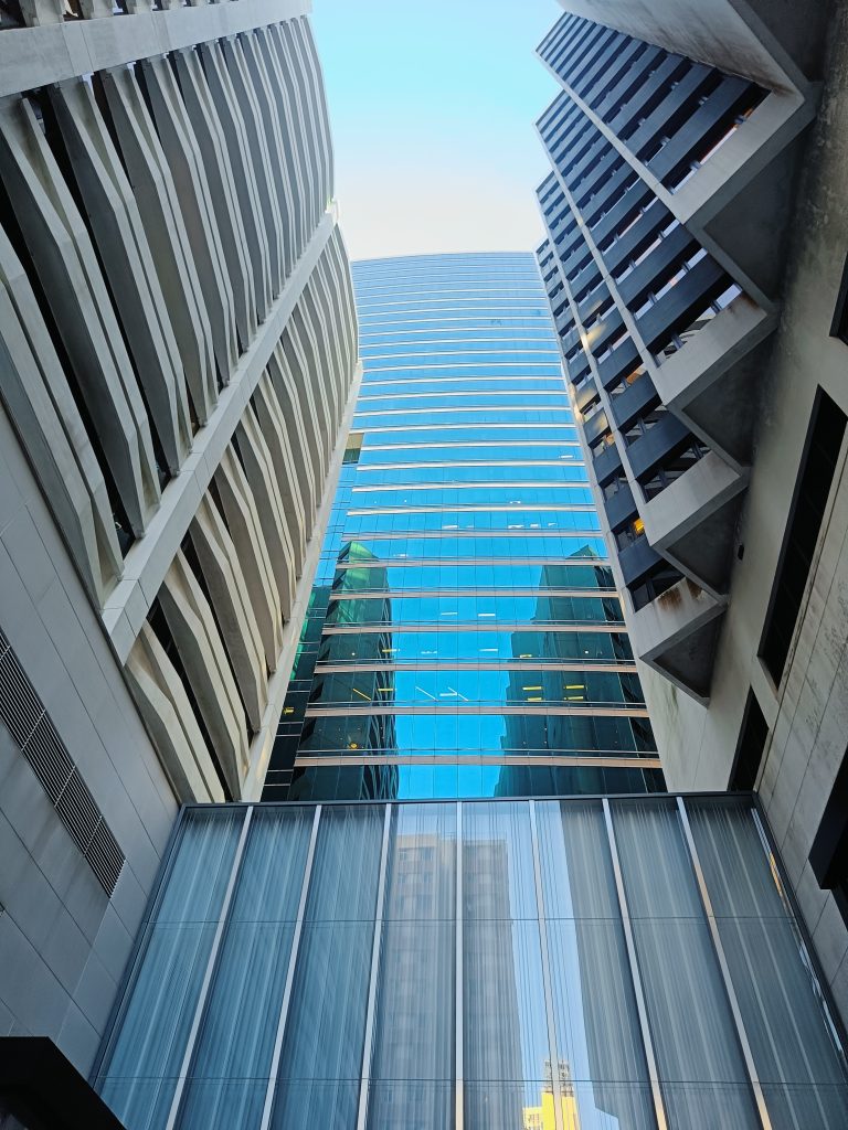 Building with a glass front looking up to the sky