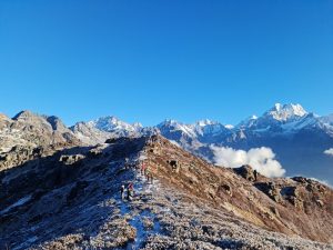 People in top Hills  and mountains in background.