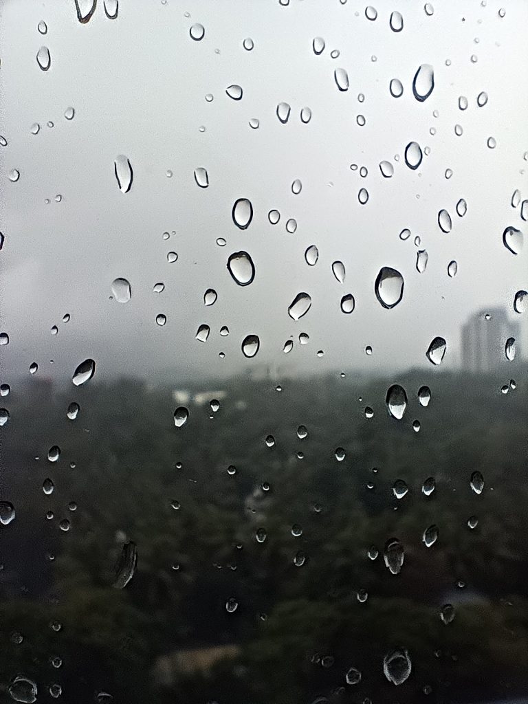 Focused image of raindrops on a glass window.