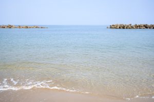 View larger photo: Sea of Japan on a sunny day. The calm water surface creates a tranquil atmosphere, It captures the pristine, sun-drenched coastline.