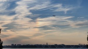 Flight final approach over the Woodrow Wilson Memorial Bridge, Maryland, USA. Dusk sky with slightly iridescent cloud
