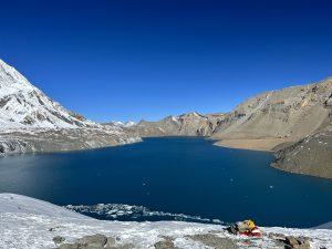 Lake view with blue sky and mountains.