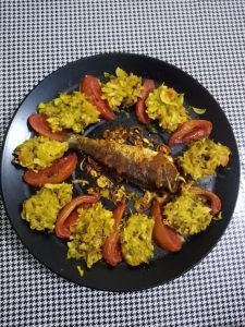 Tasty oven baked fish with cabbage and tomato.

