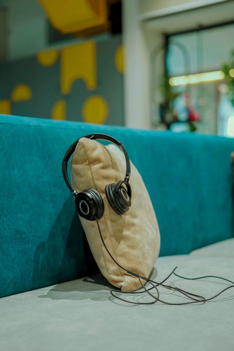 Headphones hanging on a pillow