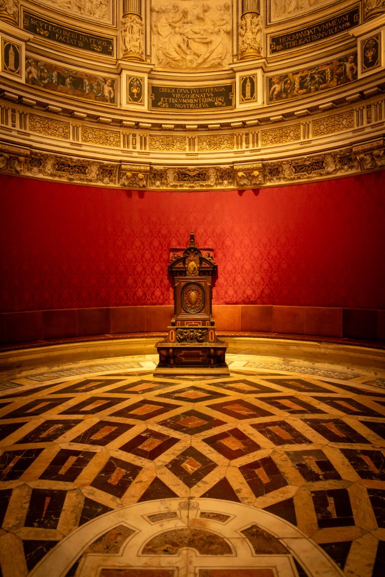 An elaborately decorated mahogany armchair in the Sala Capitular, Catedral de Sevilla, Spain.