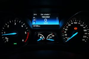 Car dashboard with blue and red indicator lights